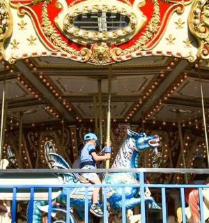 a person riding a horse on a carousel