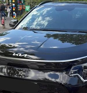 a black car parked on the side of a street