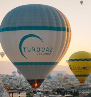 a group of hot air balloons flying over a city