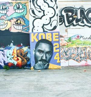 a wall covered in graffiti with a face on it