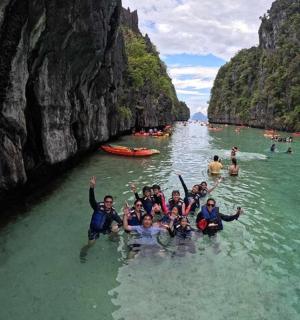 a group of people in the water in a river