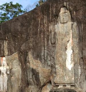a large stone wall with statues on it