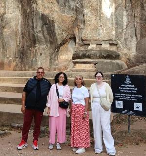 a group of people standing in front of a statue