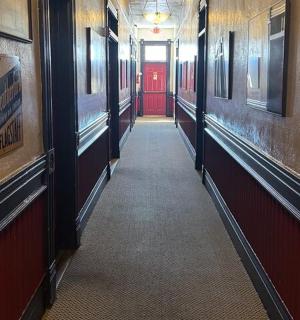a hallway with a red door in a building