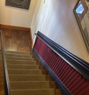 a staircase in a building with a picture on the wall