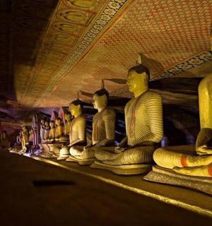 a row of statues sitting in a room