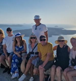 a group of people posing for a picture on a ledge