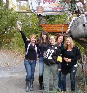 a group of women standing in front of a sign