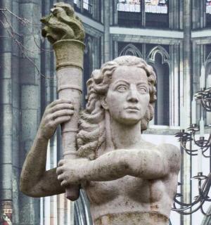 a statue holding a pole in front of a building