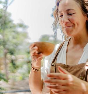 a woman in an apron looking at an apple