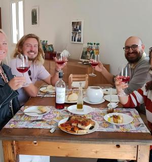 a group of people sitting around a table with wine glasses