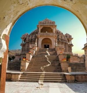 an archway leading to a large building with stairs