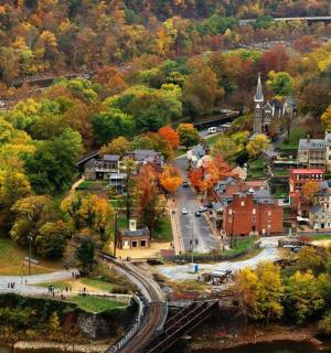 an aerial view of a small town with fall foliage