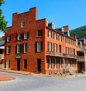 a large red brick building with people walking in front of it