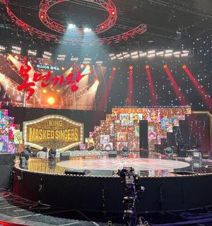 a stage with a round table in a theatre