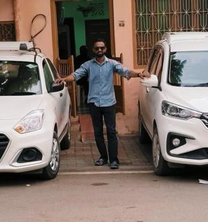 a man is standing between two white cars