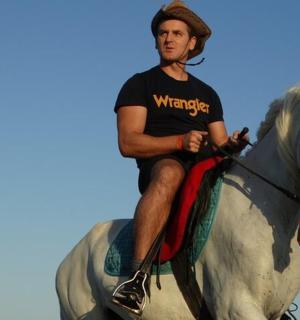 a man riding on the back of a white horse