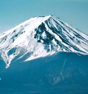 a snow covered mountain on top of the water