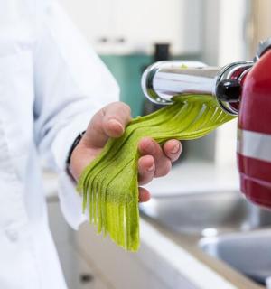 a scientist is holding a green dish brush