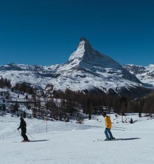 两个人在山前的雪地里滑雪