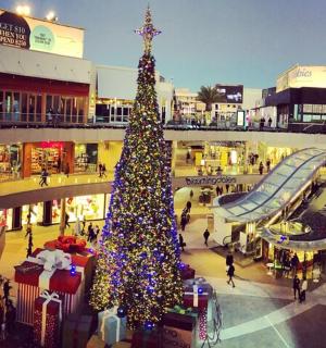 a christmas tree in the middle of a shopping mall