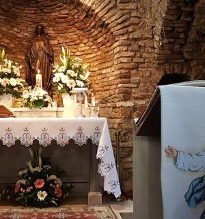 a church altar with a painting of a woman