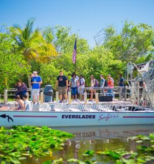 a group of people standing on a boat in the water