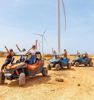 a group of people riding atvs on a dirt road
