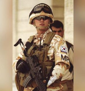 a man in a military uniform holding a gun