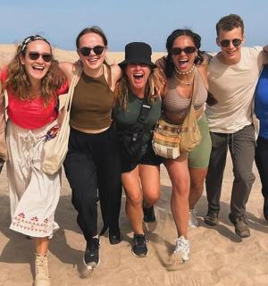 skupina lidí kráčejících pouští