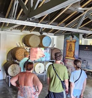 a group of people looking at clocks in a room