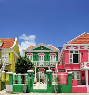 a row of colorful houses with a fence
