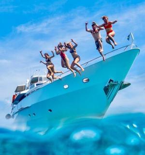 a group of people jumping off the edge of a boat