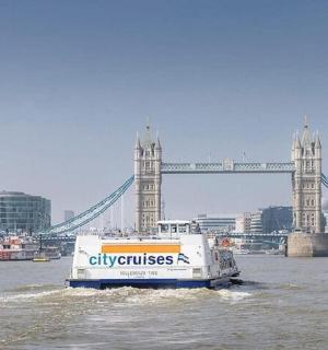 a boat in the water in front of a bridge