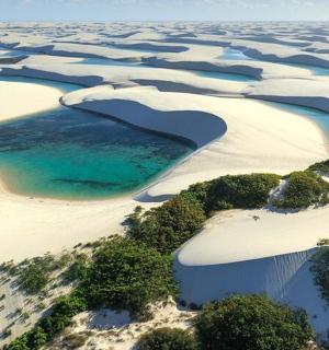 an aerial view of a beach with a body of water