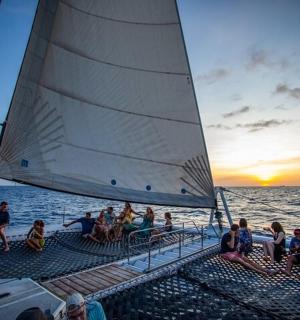 a group of people sitting on the deck of a boat