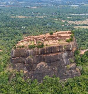an aerial view of a building on top of a mountain