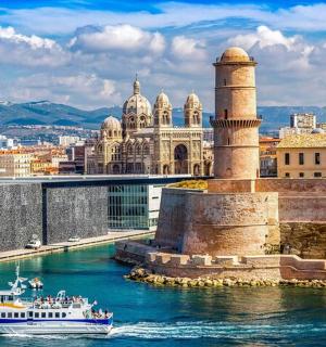 a boat in the water in front of a city