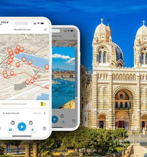 two iphones sitting next to each other in front of a building