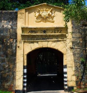 a stone building with a door with a sign on it