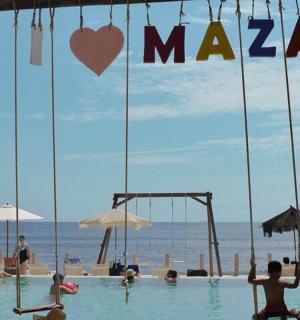 a group of people in a swimming pool at the beach