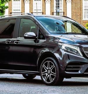 a black suv is parked on a street