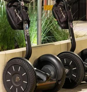 two scooters are parked next to a planter
