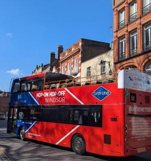 a red double decker bus parked on a city street