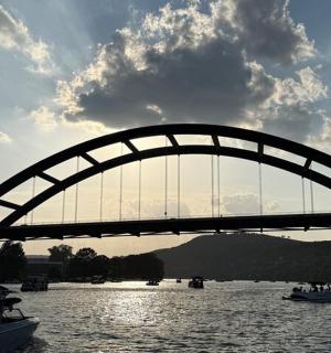 most přes řeku s loděmi ve vodě