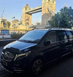 a black smart car parked in a parking lot