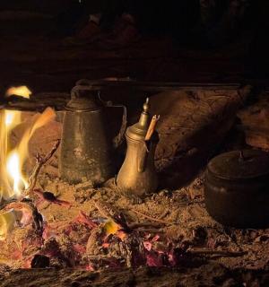 a fire with some pots and pans on top of it