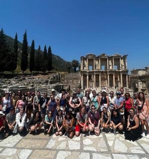 a group of people posing in front of a building