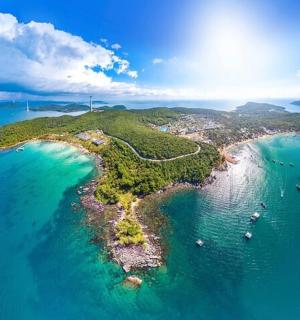 an island in the ocean with boats in the water