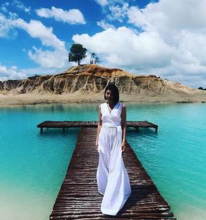 一名女子站在水中的码头上